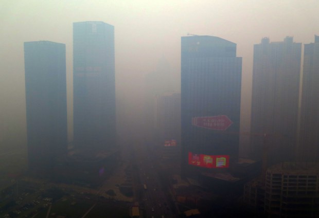 TOPSHOTS This picture taken on November 8, 2015 shows a residential block covered in smog in Shenyang, China's Liaoning province.  A swathe of China was blanketed with dangerous acrid smog after levels of the most dangerous particulates reached almost 50 times World Health Organization maximums.         CHINA OUT AFP PHOTOSTR/AFP/Getty Images